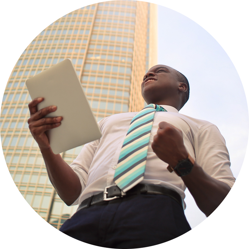 Man in front of building holds notebook