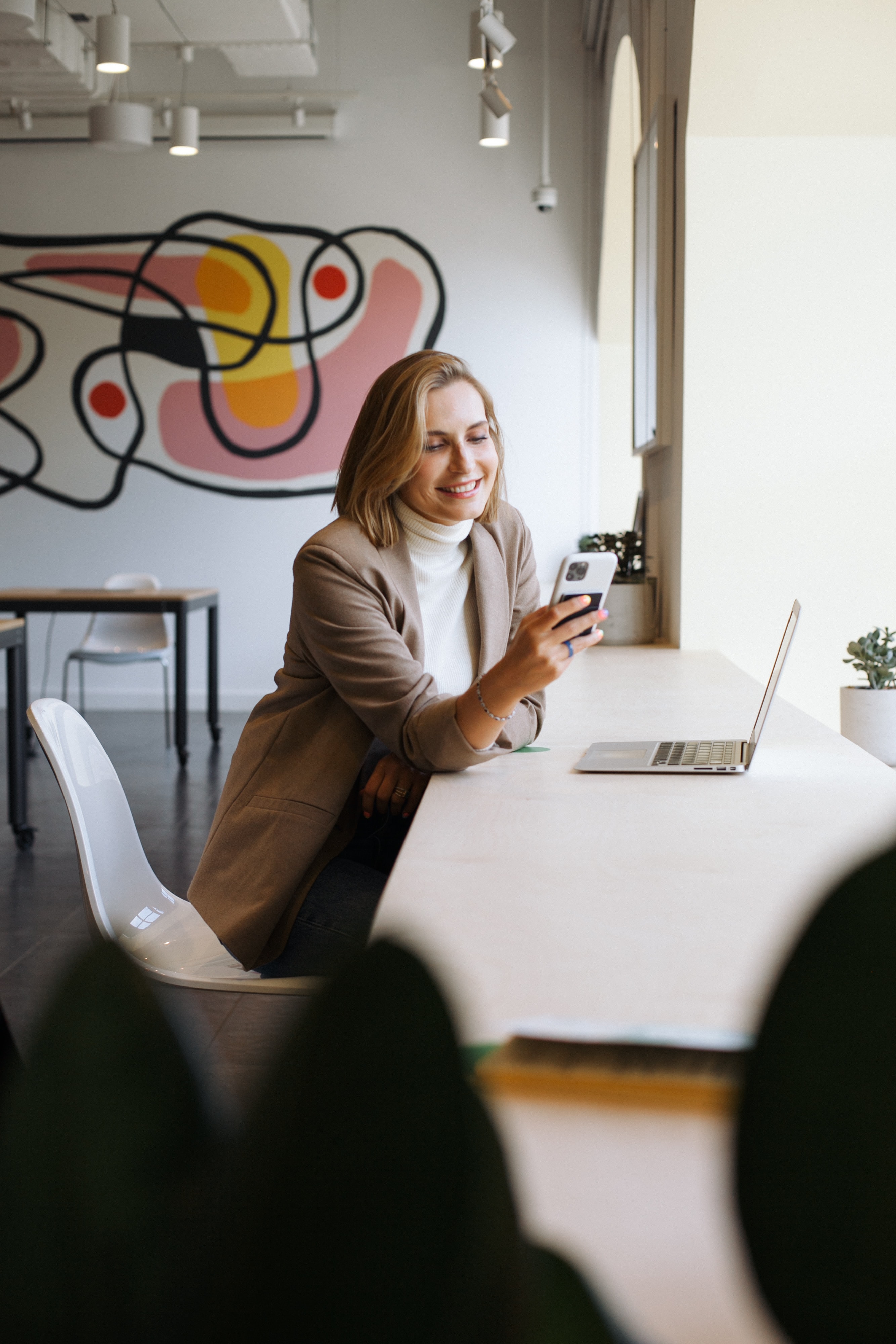 Woman smiles while using phone