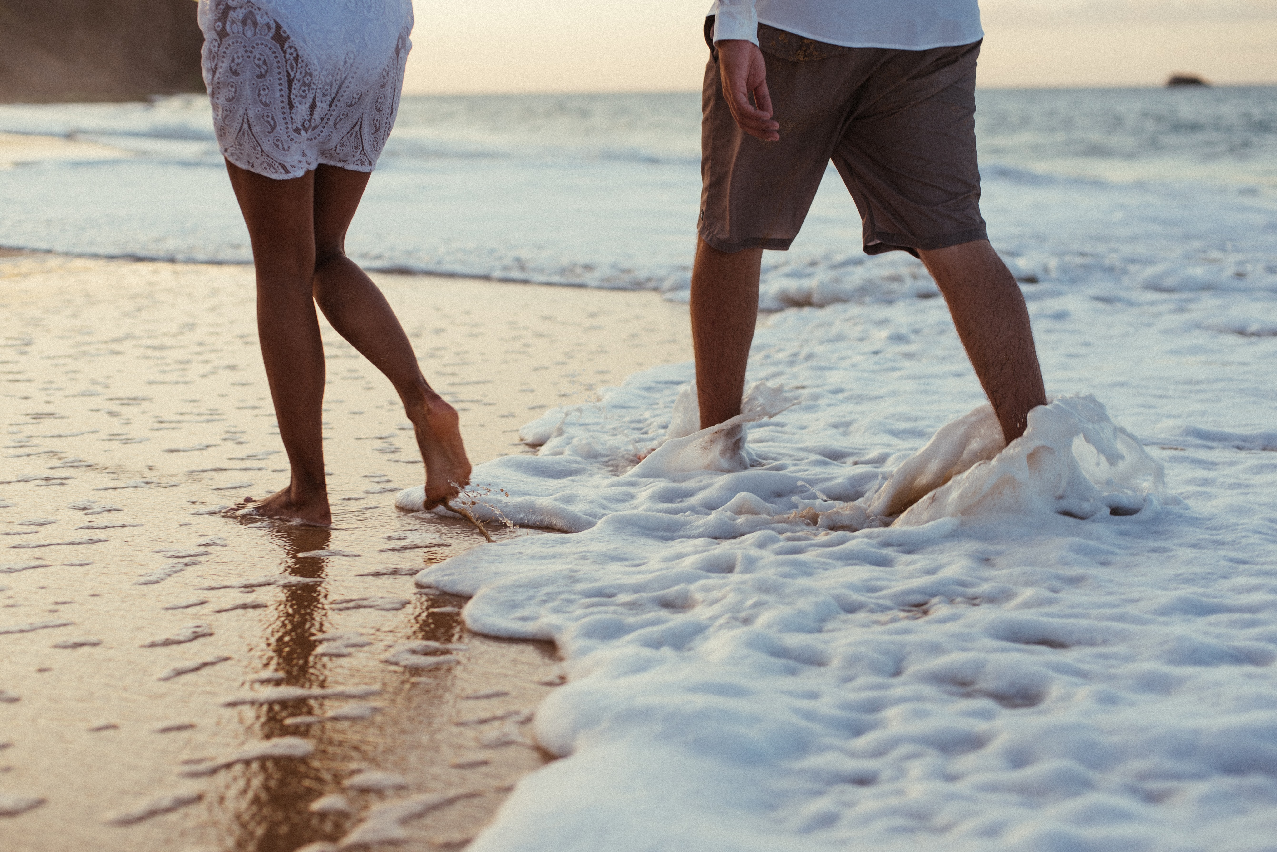 Two people step into the ocean