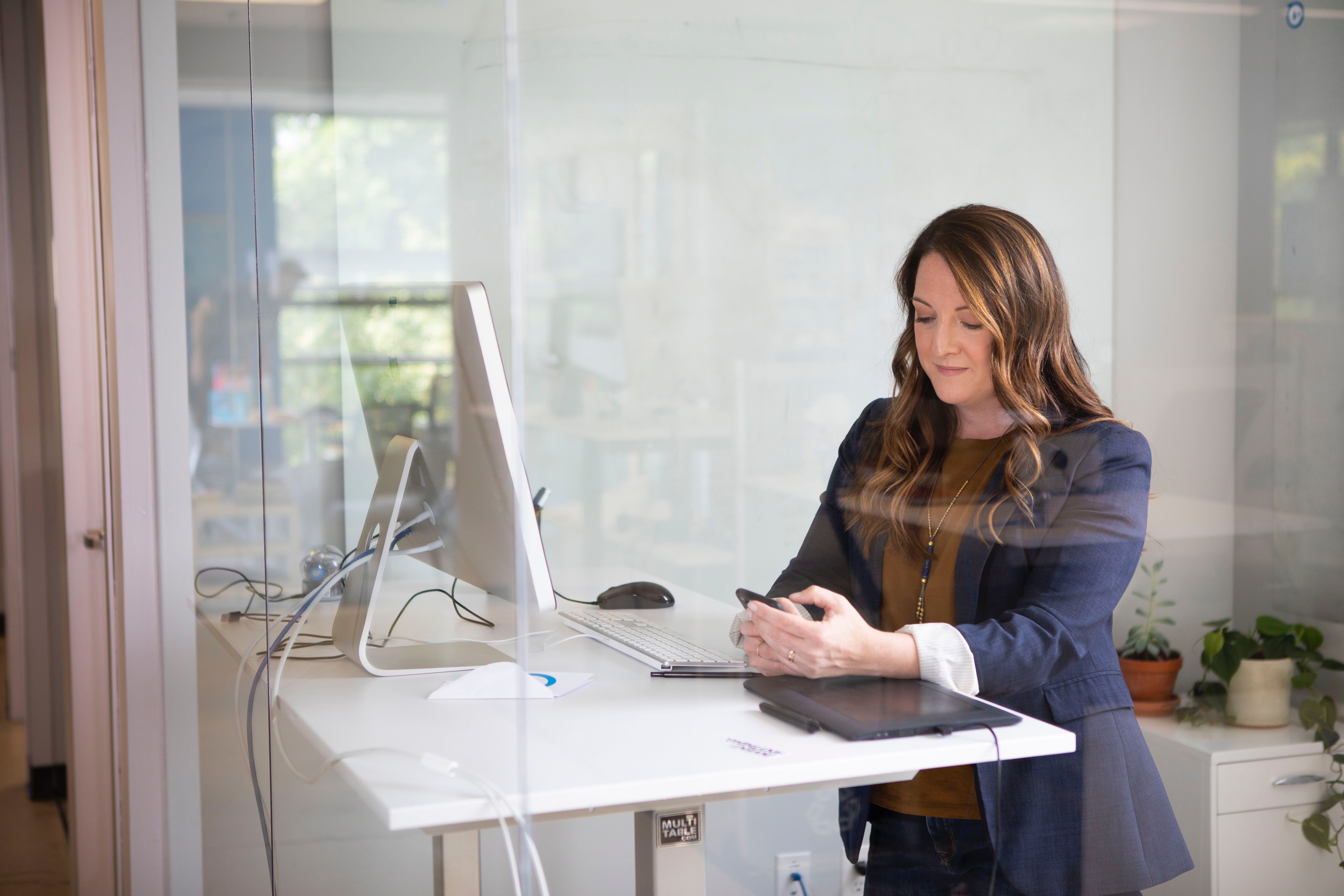 Woman stands at desk