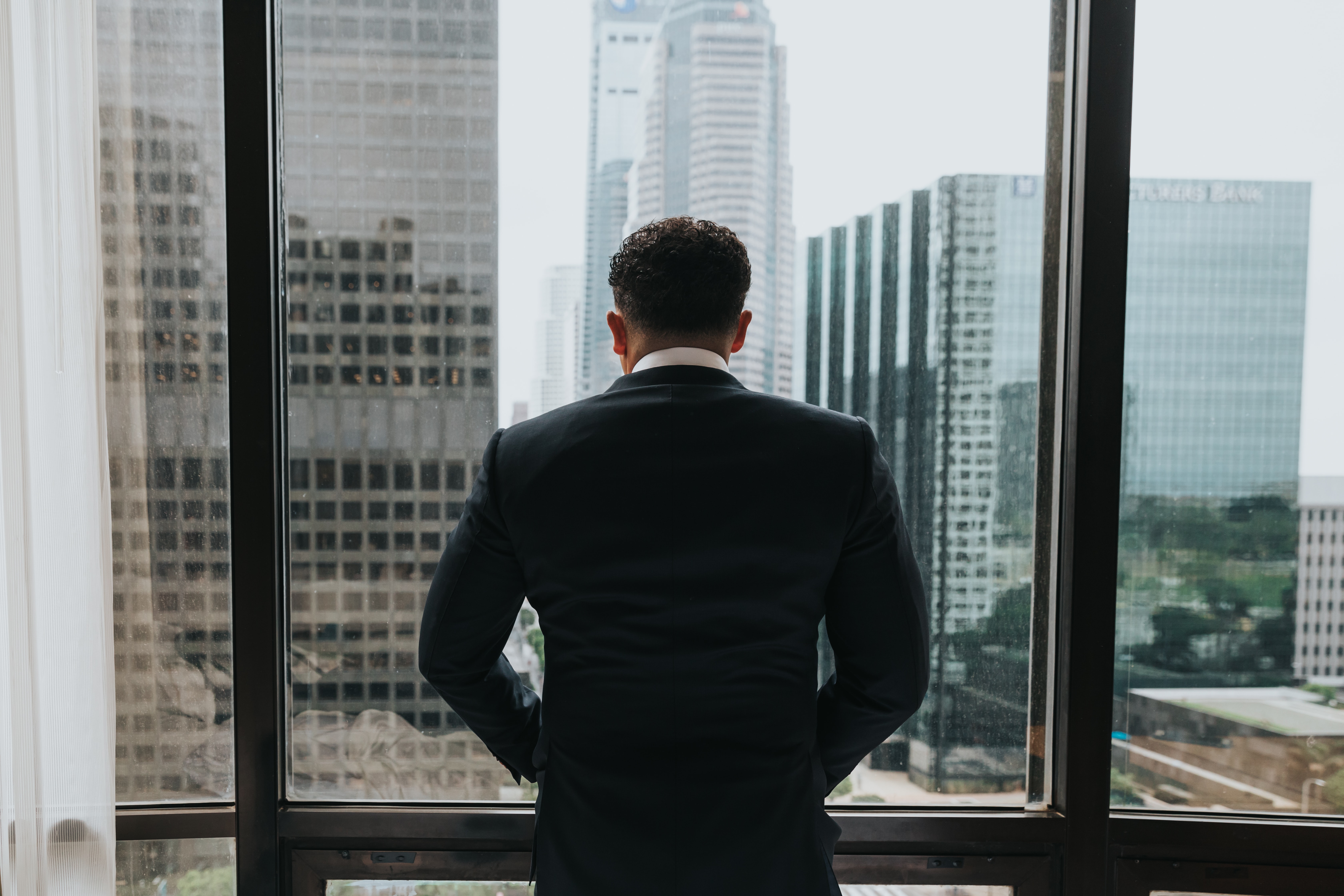 Man looks outside window